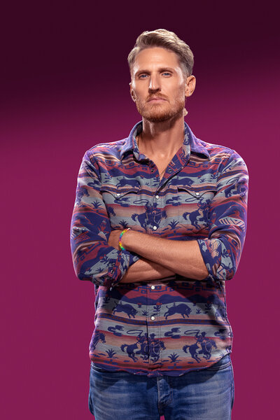 Tyson Apostol standing in front of a purple backdrop in House of Villains Season 3.