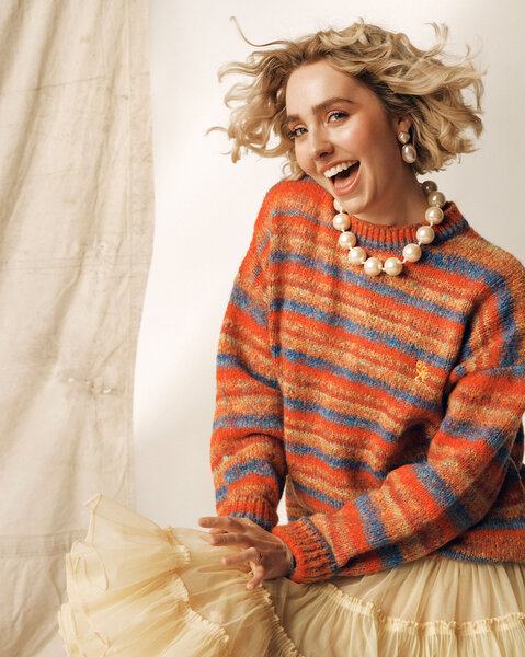 Annabel Marlow posing in front of a cream backdrop.