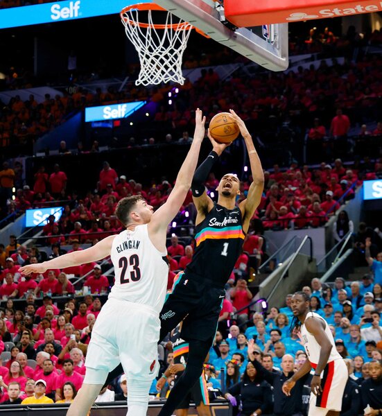 Victor Wembanyama of the San Antonio Spurs scores over Donovan Clinton of the Portland Trailblazers in the second half of Game One of the Western Conference First Round NBA Playoffs.