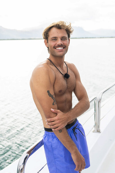 Gal Tshnieder smiling in blue swim trunks in Love Island USA Season 8.