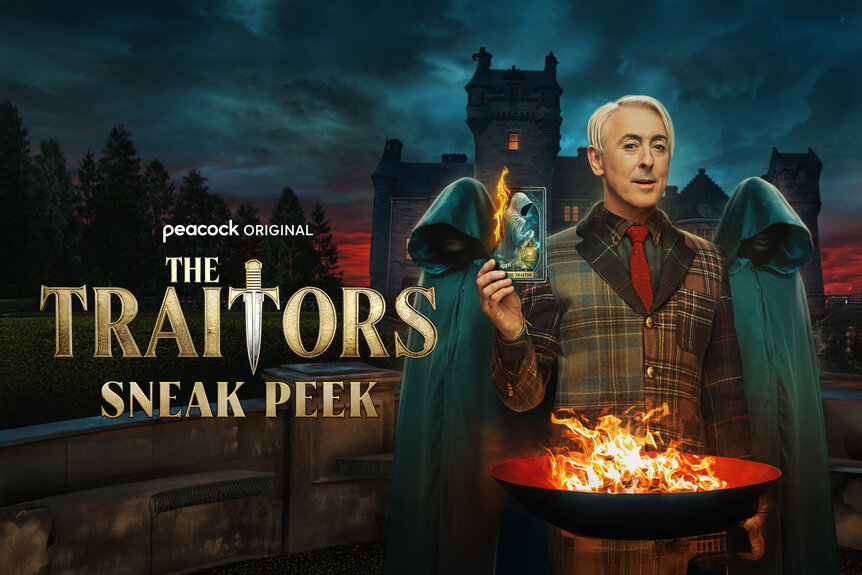 Alan Cummin behind a fire with two traitors by his side in front of a castle