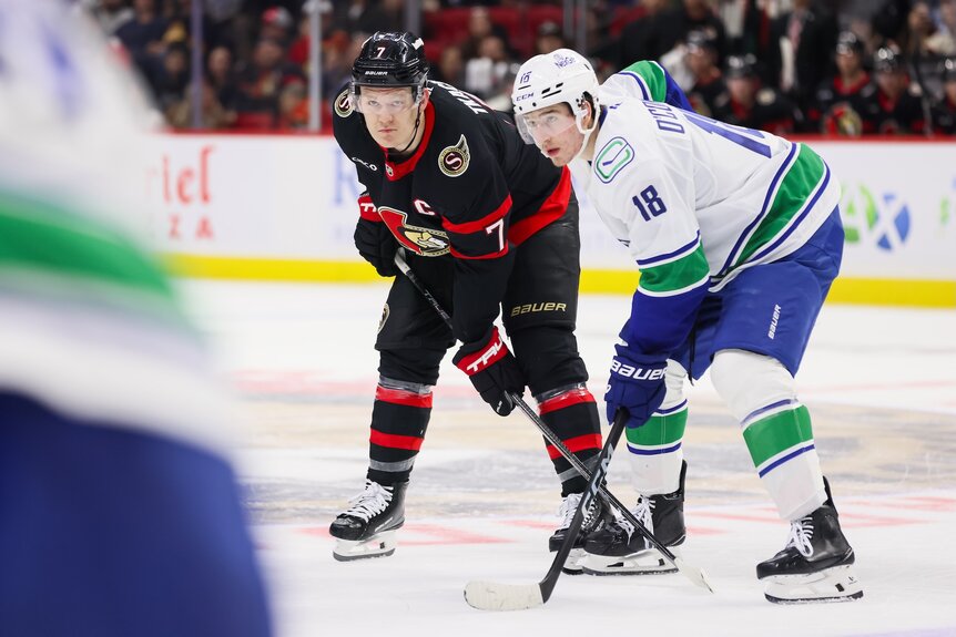 Brady Tkachuk #7 of the Ottawa Senators and Drew O'Connor #18 of the Vancouver Canucks before a face-off during a game.