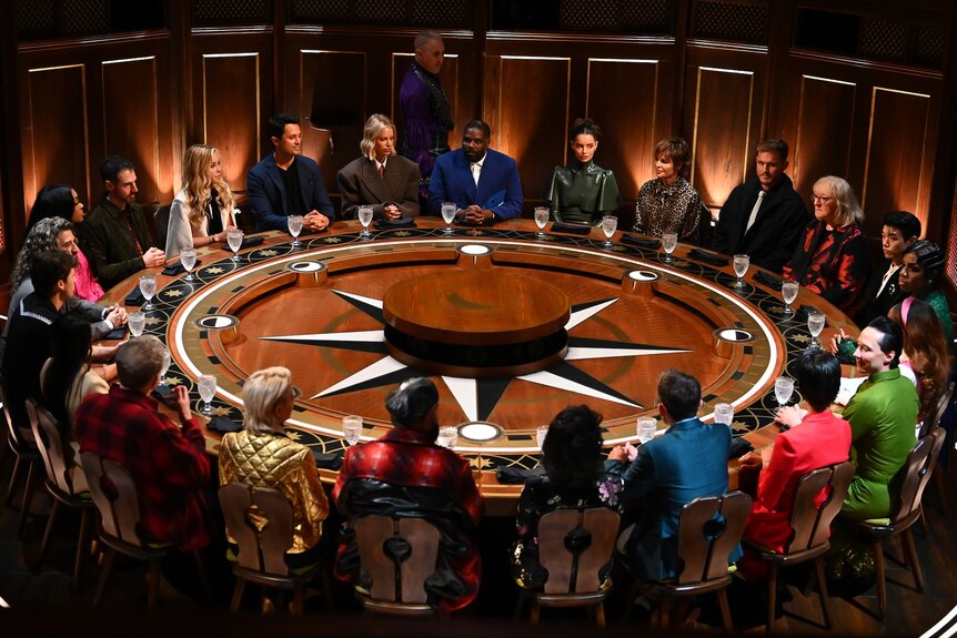The cast of The Traitors gather around a giant round table on Episode 401