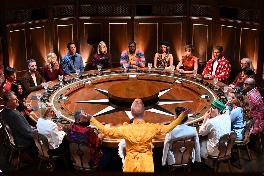 The cast of The Traitors gather around a giant round table on Episode 403.