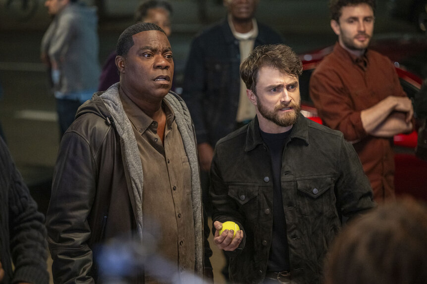 Reggie Dinkins (Tracy Morgan) and Arthur Tobin (Daniel Radcliffe) standing together on The Fall and Rise of Reggie Dinkins Season 1 Episode 3.