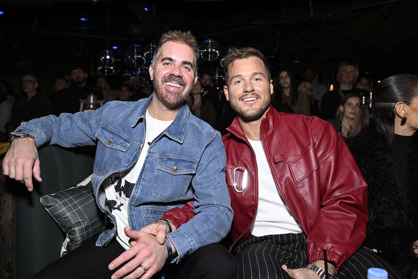 Jordan C. Brown and Colton Underwood hold hands at The Traitors Season 4 Premiere Watch Party.