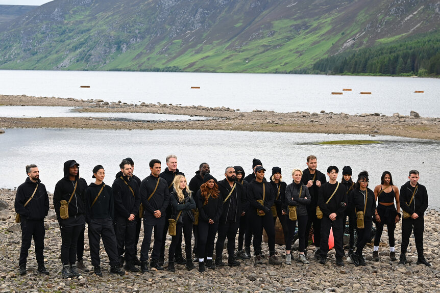 The cast of The Traitors Season 4 in front of a river on a mountain side.