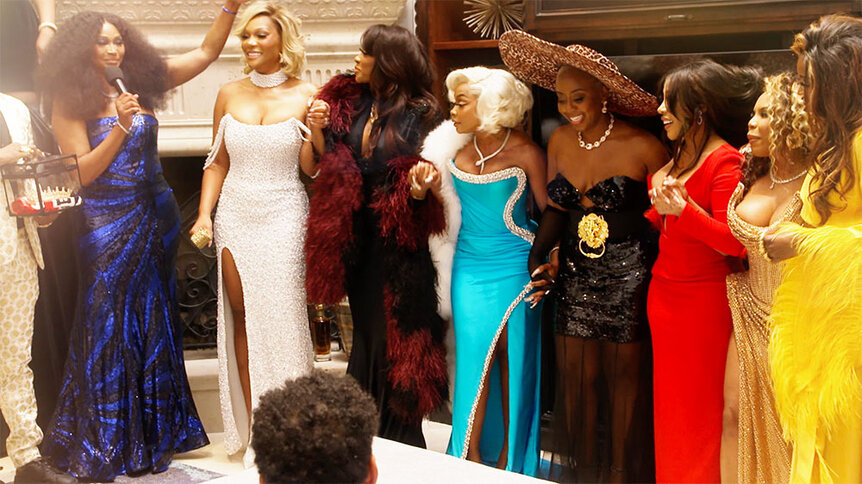 The cast smiling wearing gowns in The Real Housewives of Atlanta Season 17.
