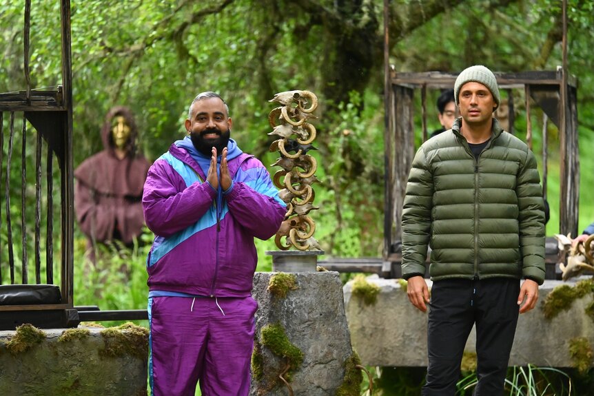 Yamil “Yam Yam” Arocho and Stephen Colletti stand outside near a sheeps skull sculpture on The Traitors Episode 403.
