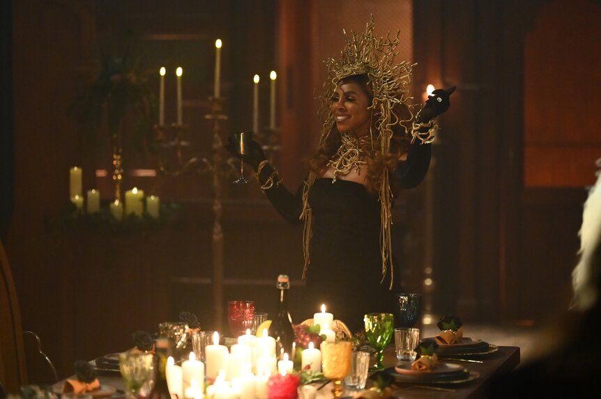 Candiace Dillard Bassett toasts in a golden headpiece on The Traitors Episode 407.