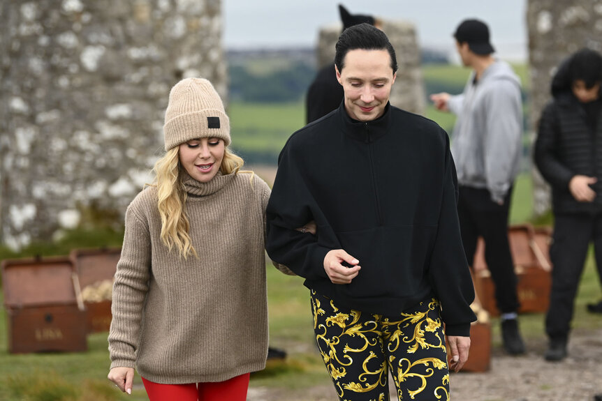Tara Lipinski and Johnny Weir walk and talk together during The Traitors Season 4 Episode 7.