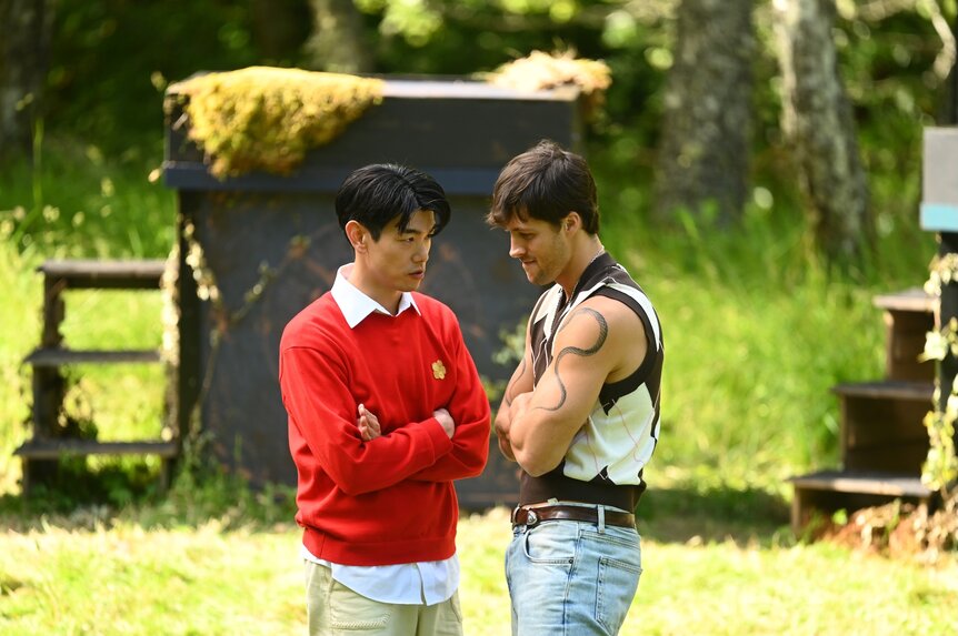 Eric Nam and Rob Rausch huddle together outside on The Traitors Episode 409 .