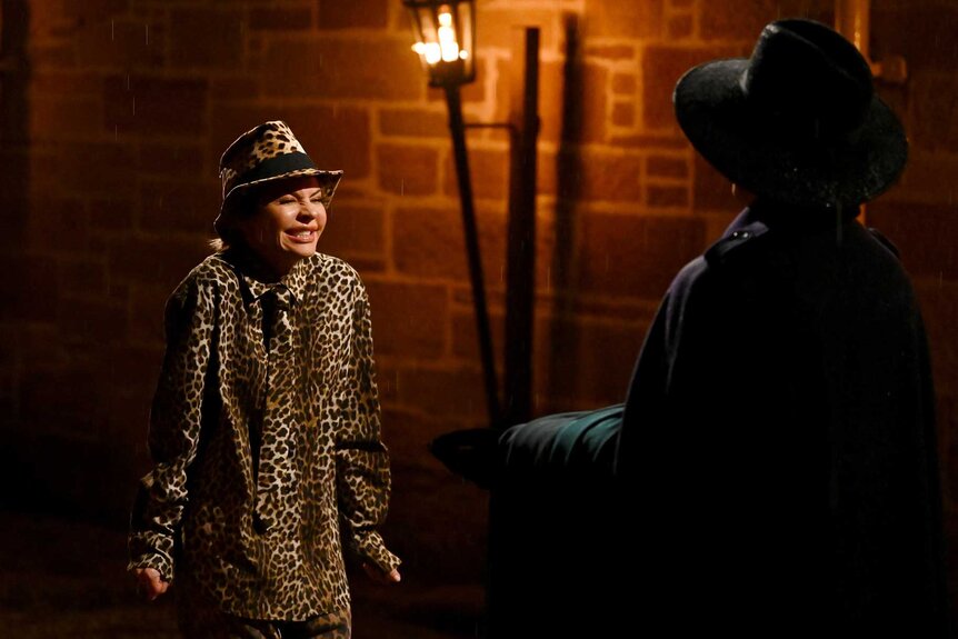 Lisa Rinna looking at a shadow figure on The Traitors Season 4 Episode 1.