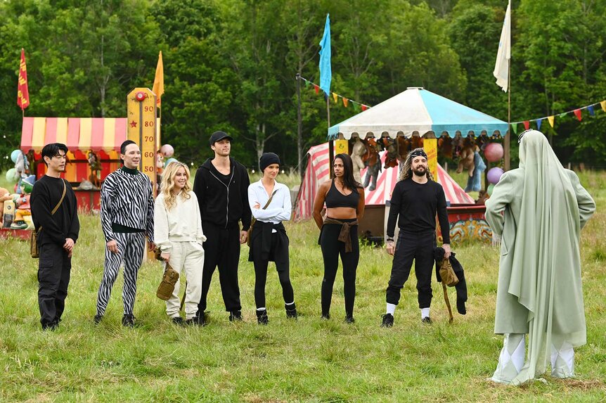 Eric Nam, Johnny Weir, Tara Lipinski, Rob Rausch, Maura Higgins, Natalie Anderson, and Mark Ballas outside together on The Traitors Season 4 Episode 10.