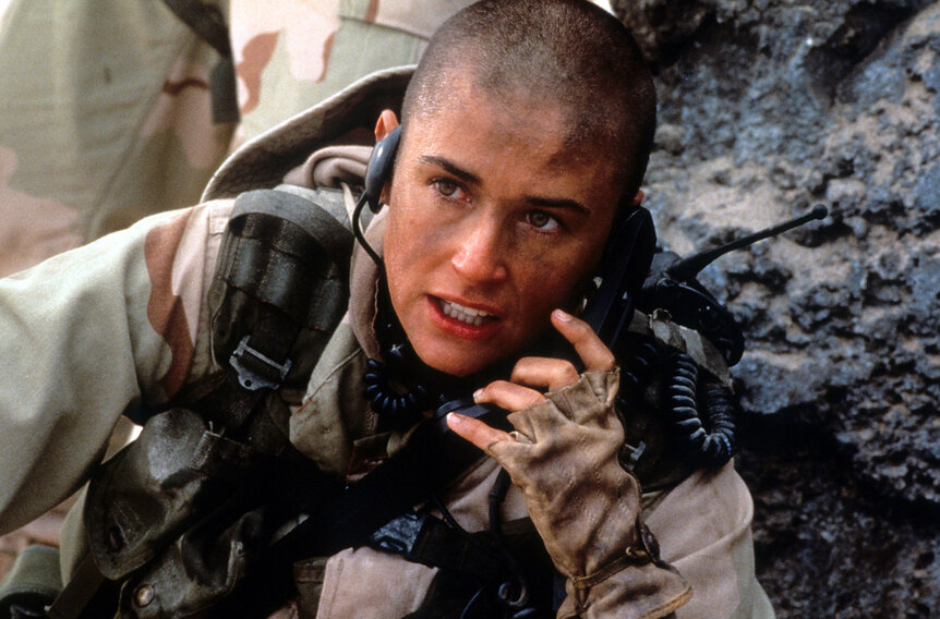 Demi Moore talking on walkie talkie in a scene from the film 'G.I. Jane', (1997).