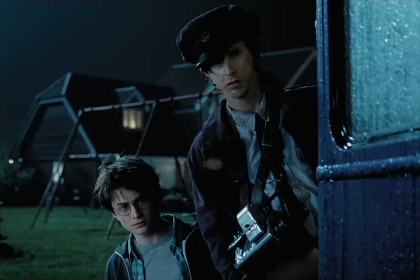 Harry Potter and train conductor, Stan Shunpike, looking out the Knight Bus in Harry Potter and the Prisoner of Azkaban (2004).