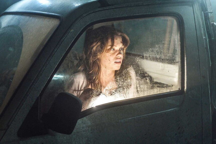 Sophie Roberts sitting in a car in Leprechaun Origins (2014).