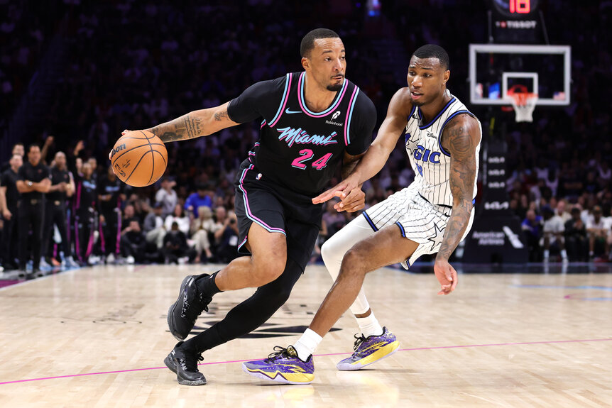 Norman Powell of the Miami Heat dribbles the ball against Jamal Cain of the Orlando Magic during the fourth quarter of the game at Kaseya Center