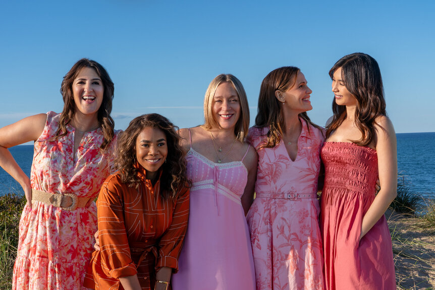 The full cast of The Five Star Weekend Season 1 standing in front of an ocean view.