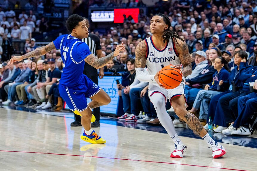 Solo Ball of the Connecticut Huskies is defended by Adam Clark of the Seton Hall Pirates.