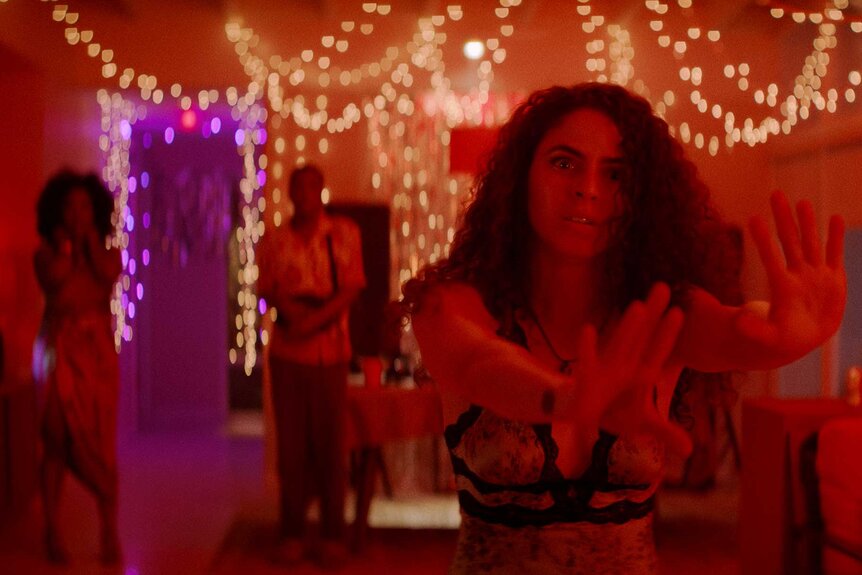 A woman holding her hands out in M.I.A. Season 1.