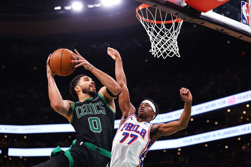 Jayson Tatum of the Boston Celtics shoots the ball against VJ Edgecombe of the Philadelphia 76ers during the fourth quarter.