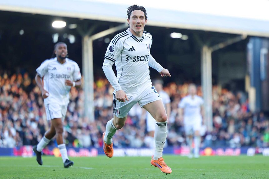 Harry Wilson of Fulham running and celebrating on the field during the Premier League match between Fulham and Burnley.