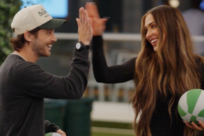 Liam Obergfoll and Ariana Biermann hi-five each other.