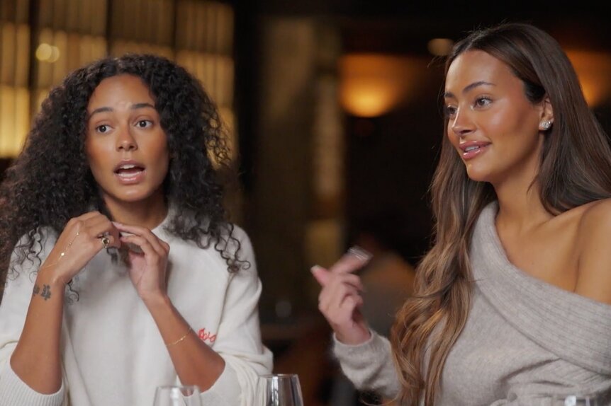 Ava Dash and Emira DSpain sitting next to each other at a restaurant.