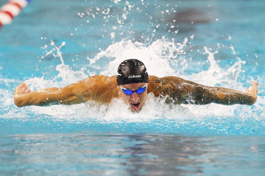 Caeleb Dressel swimming in the pool during the men's 100 meter butterfly preliminary heat on day three of the Toyota US Open Championships.