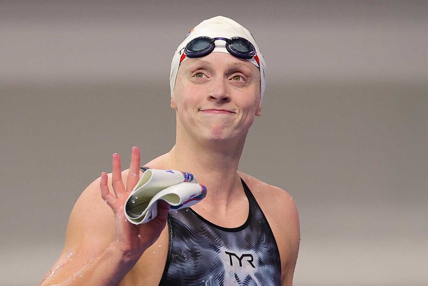 Katie Ledecky smiling and waving after winning the Women's 800 Meter Freestyle final during the USA Swimming Pro Swim Series Austin.