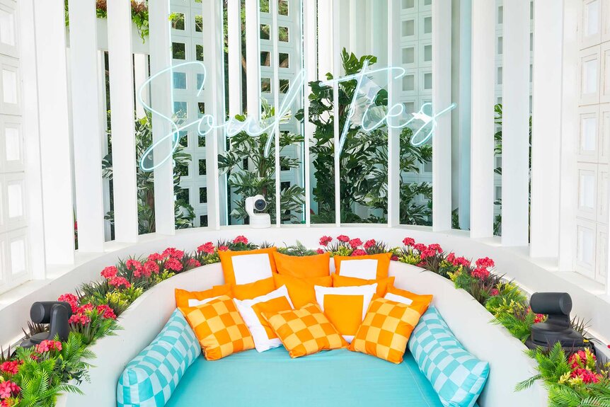 A blue and orange couch within the villa on Love Island USA Season 7.