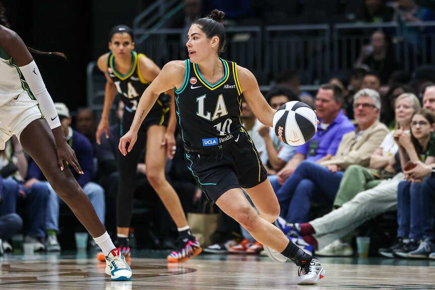 Kelsey Plum of the Los Angeles Sparks controls the ball during the first quarter against the Seattle Storm.