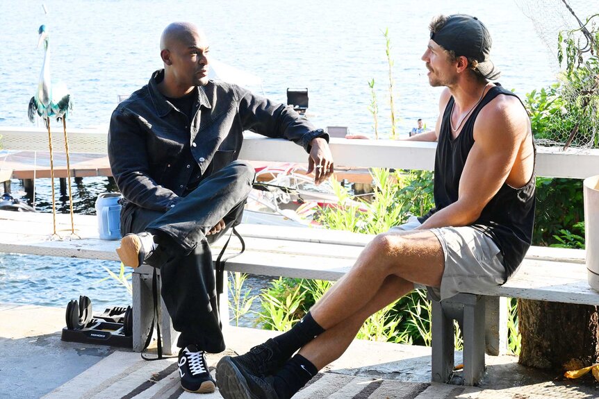 Paul C. Brunson and Adam Dehmlow talking by the water on Married at First Sight Season 20 Episode 1.