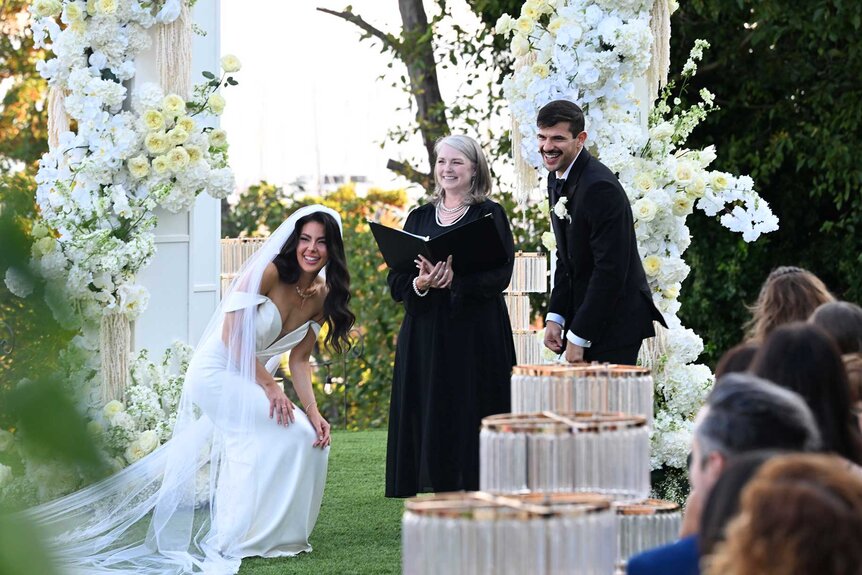 Tori Dahl and Felipe Cruz standing at the alter and smiling on Married at First Sight Season 20 Episode 1.