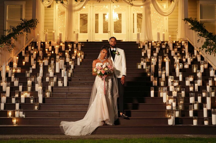 BelleJolie Force and Mecca Amen posing outside in front of wedding decor on Married at First Sight Season 20 Episode 1.