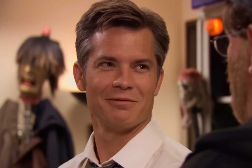 Danny Cordray smiling while talking to someone in The Office Season 7 Episode 6.
