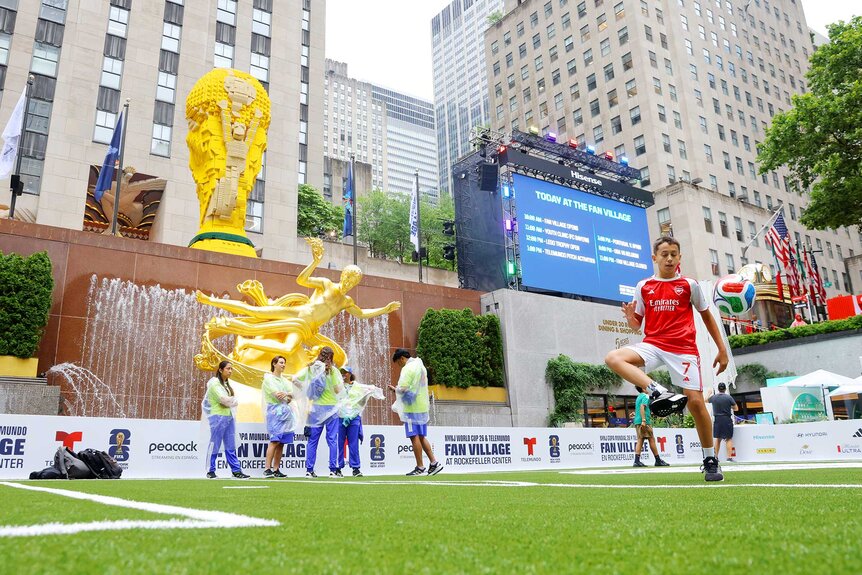 Fans playing in the grass at the FIFA World Cup 2026 Fan Village.