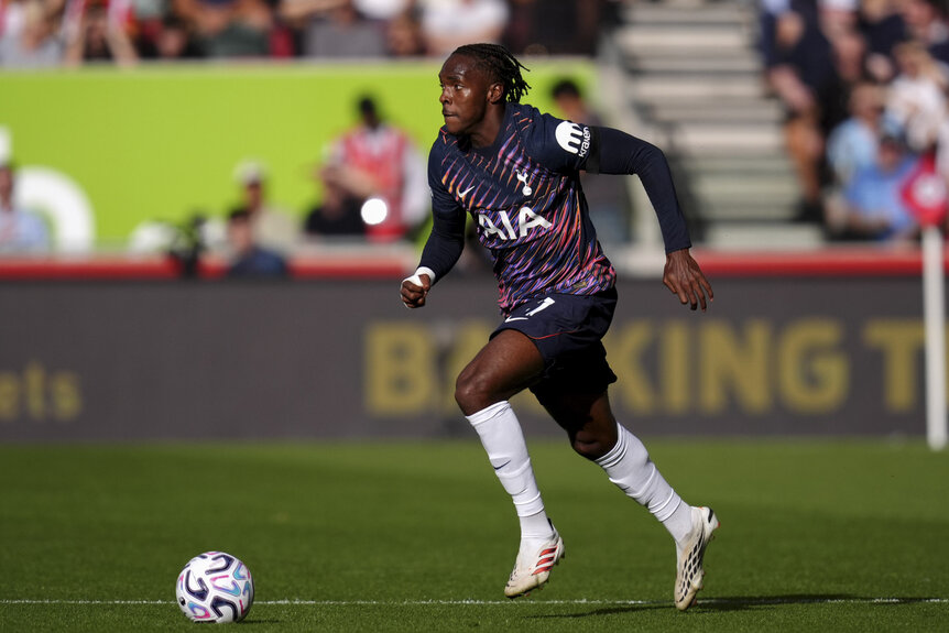 Tottenham Hotspur's Mathys Tel running with a soccer ball during a match.
