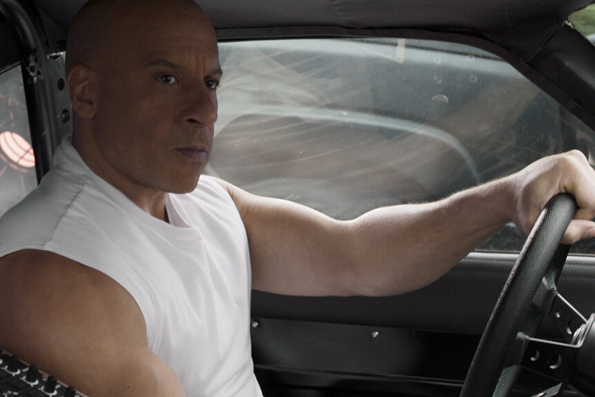 Dom Toretto (Vin Diesel) driving a car in F9: The Fast Saga (2021).
