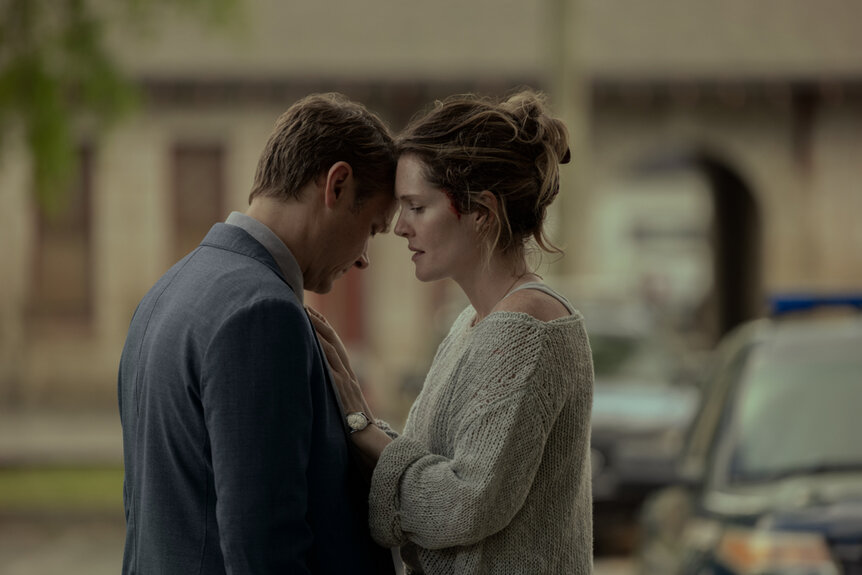 Michael Dorman as Ben and Meghann Fahy as Charlie embracing each other outside during The Good Daughter Season 1.